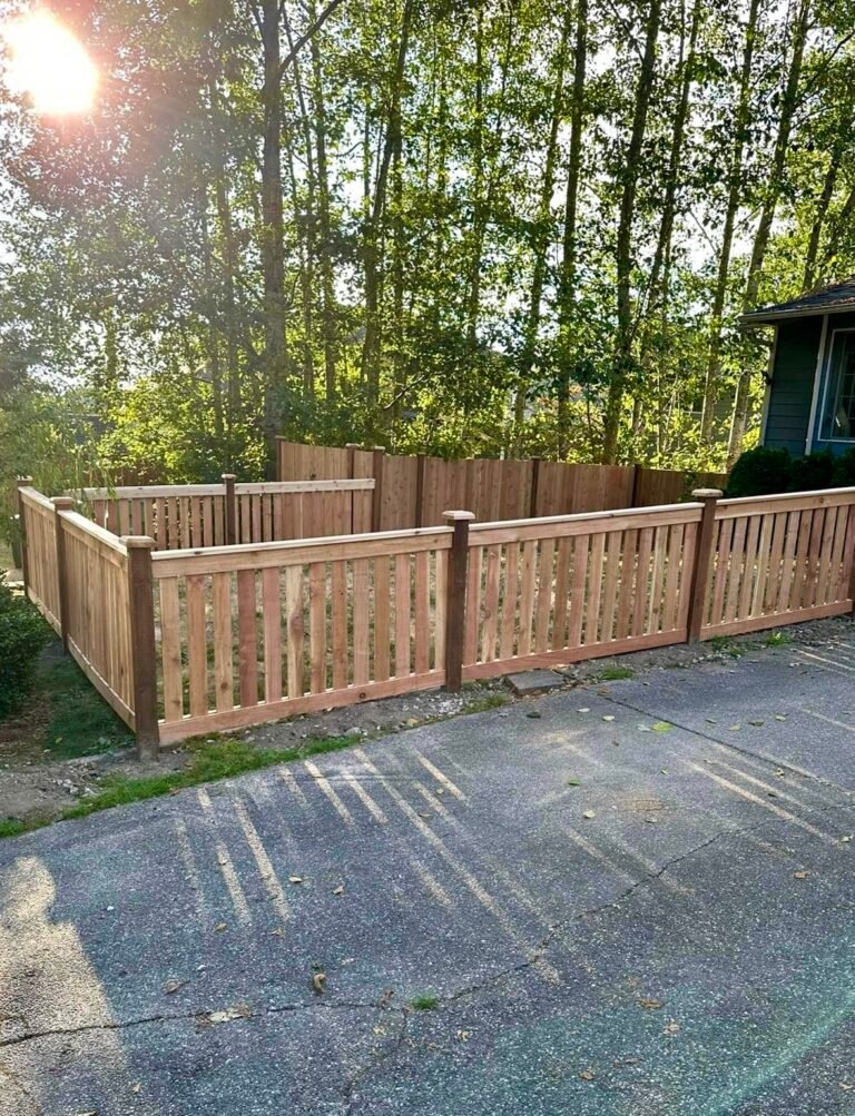 Cedar picket fence enclosing a front yard